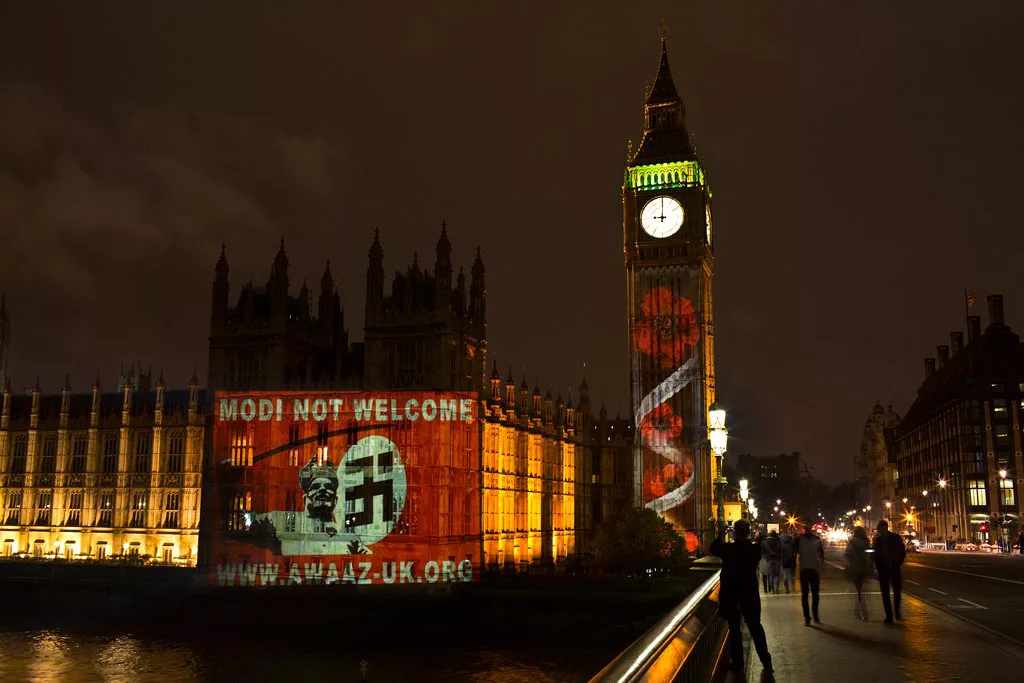 ModiNotWelcome Awaaz Netowrk campaign projected this poster on the UK Parliament